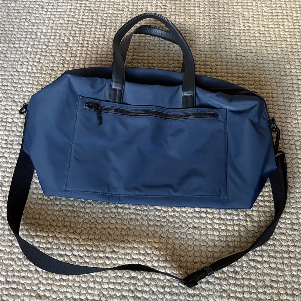 Away computer/travel tote in navy with black handles and zippers.  Like new.
